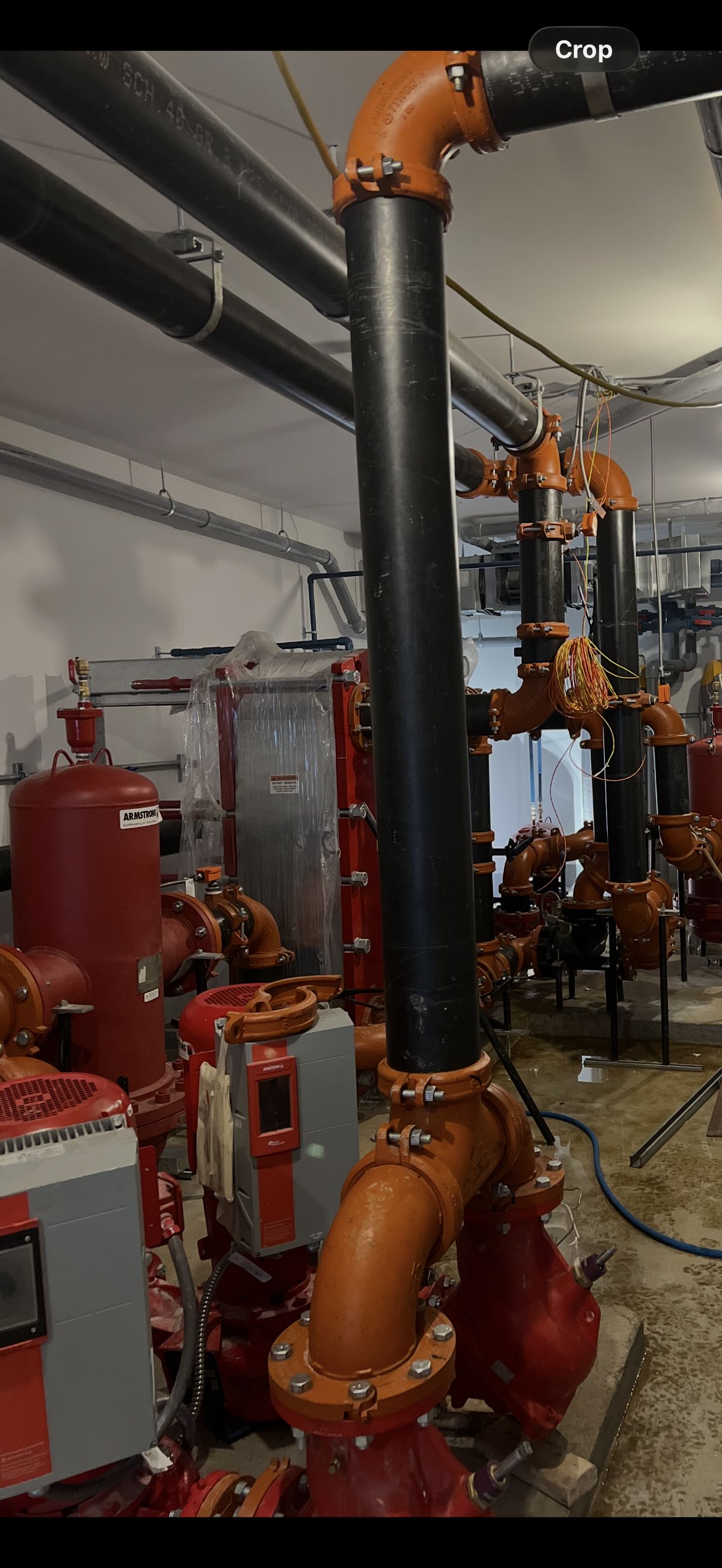 Commercial mechanical room orange pipes