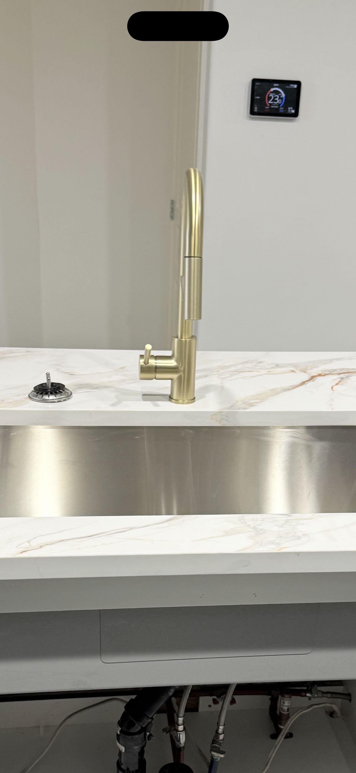 Brushed gold faucet on marble countertop
